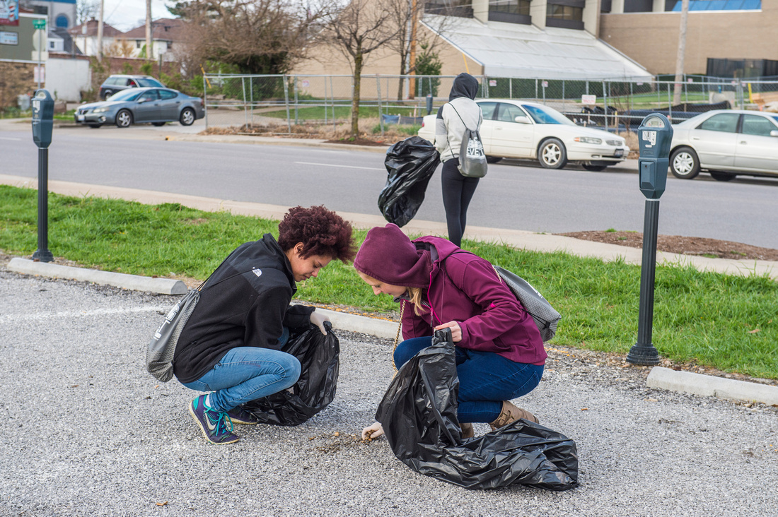 Students pick up litter.