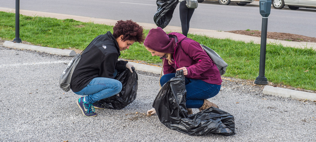 Students pick up litter.